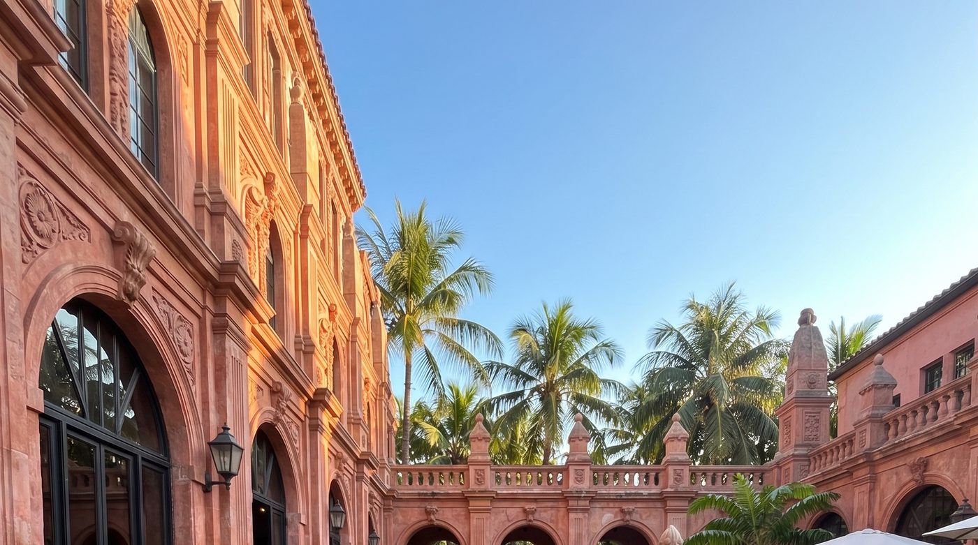 Brunch in a sunny Miami courtyard with palm trees and pink arches